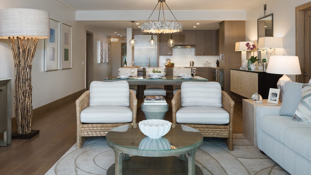 A wide view of a modern living room and kitchen with a dining area.
