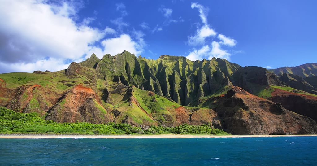 Jagged hills from catamaran at the dramatic Na Pali coast of Kauai, Hawaii Islands.