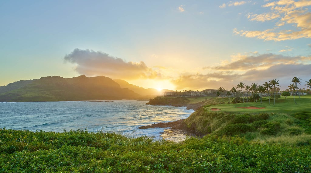 Sunsetting behind Timbers Kauai and the Hāʻupu Mountains on Kauai within the Hokuala Hawaii resort, as viewed from the 14th tee of the Ocean Course at Hokuala
