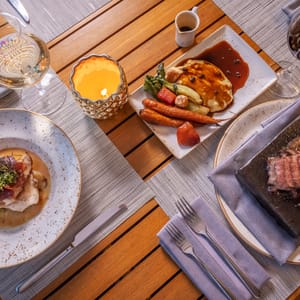 three different plates featuring menu items from Hualani's restaurant at Timbers Kaua'i