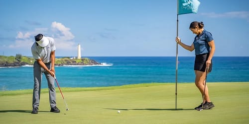two people putt on a golf course