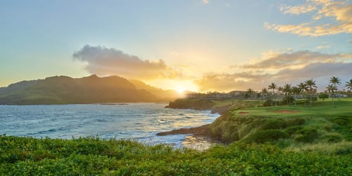 Sunsetting behind Timbers Kauai and the Hāʻupu Mountains on Kauai within the Hokuala Hawaii resort, as viewed from the 14th tee of the Ocean Course at Hokuala