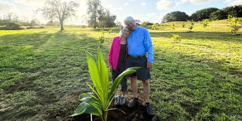 The Ortens by their coconut tree at Hokuala