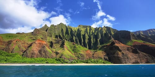 Jagged hills from catamaran at the dramatic Na Pali coast of Kauai, Hawaii Islands.