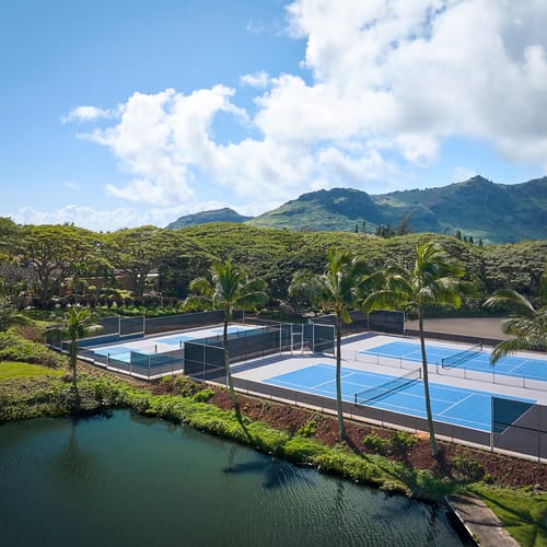 Aerial view of the Courts at Hokuala (tennis and pickleball) with the Hāʻupu Mountains in the background