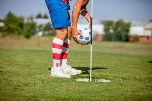 Footgolf Player Picking Soccer Ball from the Hole on the Golf Course